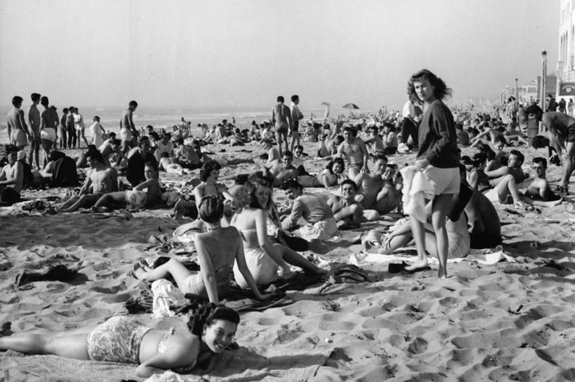 Taken in 1947, the year I graduated from Santa Monica High School. Looks like the gang I hung out with then. Notice that there are very few umbrellas. We quit using them in the 40's. And now that I am in my 80's I visit the dermatologist twice a year to remove that darn skin cancer. View full size.
