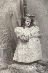 There is quite a story behind this picture. This was my great-grandmother's cousin. The picture was taken in 1896 in New Orleans, when Amy was not yet 3 (her exact age and name are on the back). It was taken in a photographer's studio near the old French Opera House. 
Anyway, she died about 2 years later along with her grandmother (my great x 3 grandmother) and her mother on the shipwreck La Bourgogne. They were going to get my great-grandmother from Switzerland, where she was staying with her other, Swiss grandmother and bring her back to New Orleans. 
After the deaths of her New Orleans grandmother, a cousin, and an aunt, my great x 2s were afraid to bring my great-grandmother home, so she spent most of her childhood in Switzerland. She, and later her daughter-in-law (my grandmother) saved this picture of her lost cousin. The Aldige family tomb in Metairie Lawn has a statue of two angels weeping on a sinking ship on it and has the inscription "In memory of mother, sister, and niece lost at sea on the steamship La Bourgogne July 4, 1898." View full size.
Amazing story And beautiful photo!
Saddest photo.What a sad story and the photo seems to highlight that sadness. Such a sweet little thing and such a lovely photo.
The tombFound here.
She&#039;s rememberedA beautiful little girl! Now that she is on Shorpy, she will be remembered every time someone looks at her picture.  Thanks for sharing it.
Thank you all so much (and more story)!Thank you all so much for your comments! I love that I have pictures from so far back in my family. Anyway, the story gets sadder.
Little Amy there was already half an orphan when she died on La Bourgogne because her father, Dr. Robert Border, died months after she was born. 
Also, my greatx3, Alice Lepretre Aldige, Amy's grandmother that died with her on La Bourgogne, was on the La Bourgogne in 1893, five years earlier. She was bringing home the body of her husband, my greatx3 Jules Aldige, who was King of Carnival in 1884, btw. He died when they were in Paris. 
(ShorpyBlog, Member Gallery)