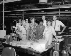 Another photo from my grandparents' album, early to mid 60's I think. The woman on the far right is the lucky recipient of all the gifts, including the money tree on the left. My grandmother is next to the money tree front row left. I wonder if they celebrated on the clock or during lunch break. View full size.