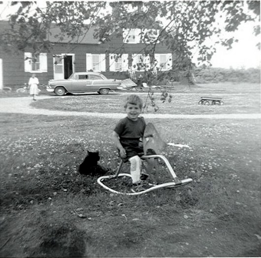 I am not sure which of the Dostie kids this one is, maybe David. But he seems to be having fun on his rocking horse, or moose, don't know. Sometime in the 1950s in Weeks Mill, Maine. Bonus: ID the car. View full size.
