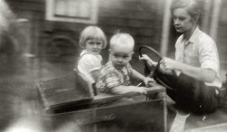 1958. Homemade go-cart, complete with baby seat.  Me, my brother, and my mom riding in a go-cart my dad made for the family.  View full size.