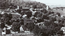 The Hartwell levee on the Illinois River broke on April 23, 1922. In this photo, water can be seen creeping towards town out in the distance. View full size.