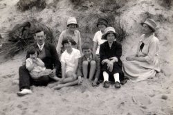 A family outing to the coast of Scotland, circa 1929. My mother is sitting in my grandfather's lap. Her cousins Margaret and George are in the middle. To the right of them is the maid, who came along on most family trips. Great Aunt Susie (Suzanne) is eyeing my mother. My grandmother is in the back with the dark hat. View full size.