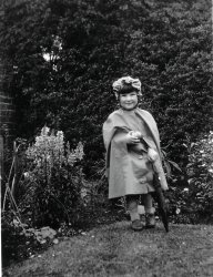 My mother, age about 4 (1928), in Dumfries, Scotland, dressed for the weather. View full size.