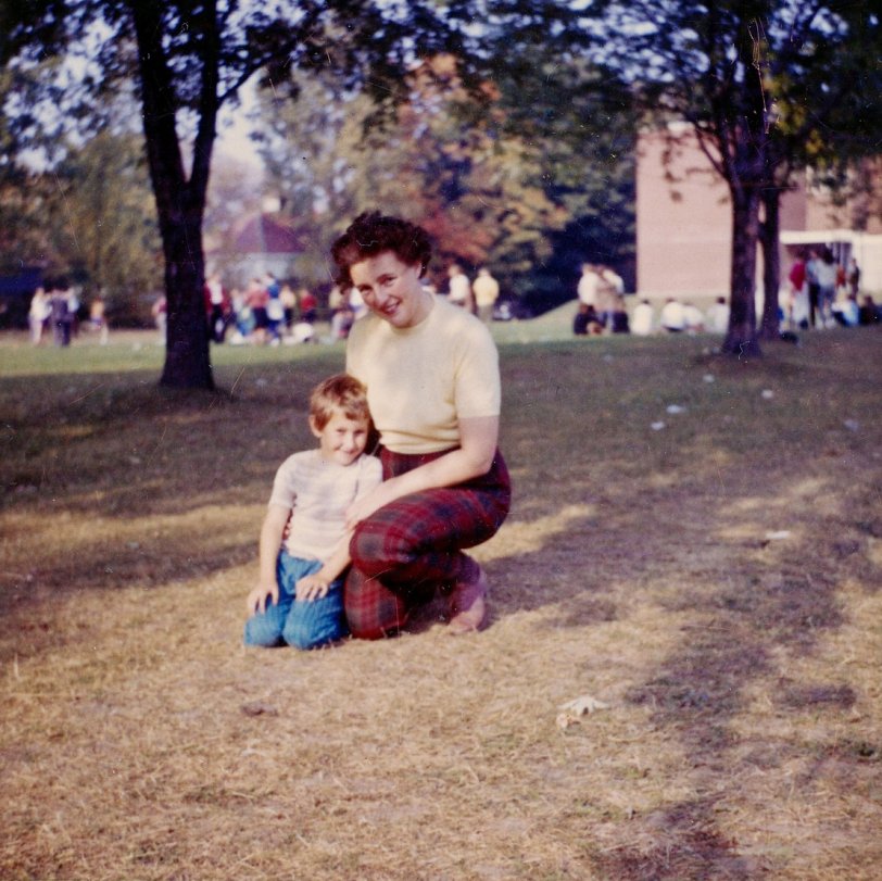 My mother and me at the North Grenville District High School field day, in Kemptville, Ontario. This would have been after our visit to Scotland. My mother had a rinse done to her hair before we left and didn't account for the effect of salt water on it. She came back with bright red hair. I would be 5 or 6, depending on whether this is before or after my birthday in September.
By the same time the next year, I had acquired a whole new family when my Mom met and married my step-Dad (she put an ad in the big city paper, got 50 replies, including one from the town bootlegger. Dad's was the 50th) and I acquired a step-brother and step-sister. We lived reasonably happily ever after.
 View full size.
