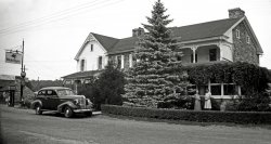 This is the old family home in Honey Grove, Pennsylvania, seen here when it was J.M. Long's Store and Post Office (on the left side) and the home of Harvey and Grace Henry (on the right side). This later became my grandfather's store and funeral home. The building still stands, looking much worse, and is no longer in my family. The figures standing in front of the building are my great-great-grandmother and great-grandmother. View full size.
Just before the warThis must have been taken just before the war but not earlier than the fall of 1937, because the car in the picture is a rather pristine 1938 Pontiac 6 cylinder 2-door flatback sedan. Nice memento of the old family place.  
(ShorpyBlog, Member Gallery)