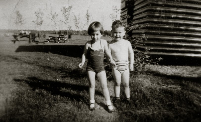 Brown's Bay Provincial Park, Ontario (near Kemptville), c. 1959. Me with my boyfriend, Michael, again. Who can resist a man who wears socks and shoes with his bathing suit? The "romance" lasted until my mother remarried and we moved to Ottawa, in 1963.
I still remember that bathing suit. Red with a pin-stripy ruffle around the top. View full size.
UPDATE! I got an email from Michael last night, out of the blue. It's been about 45 years since we last saw each other. He wrote "What a way to trigger some great memories from my young years in Kemptville. I believe that is me in the first picture but not in the second [the "Lover's Quarrel" one]; I guess you had another boyfriend [I responded that the WAS only one boyfriend for me, back then and it was Michael!]. You were responsible for my first spanking in kindergarten (actually having my hand slapped) when I got upset that you weren't sitting beside me in class."
I didn't remember that at all... But it was nice to know that at SOME point in my life I was a heartbreaker...
