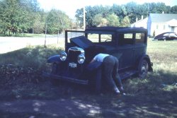 1940's in Valparaiso, Indiana.  Dad's working on his first car that he bought for $25.  I think this is after the war but I'm sure the gearheads among us can tell us the earliest possible year based on the car in the background.  The title refers to what my uncle wrote on the slide index.  He was more forthcoming with the comedy than he was with dates.  From a Kodachrome slide that was too dark so to get the car to show up I adjusted the heck out of the levels in Photoshop.  Sorry the background colors seemed to suffer a bit.  