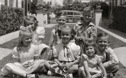 My dad around 8 years old or so, which would make this around 1946. He's in the back row on the right. My Aunt Susan is second from left, front row. Not sure exactly where it was taken other than somewhere in Los Angeles. I am thinking the other kids are cousins but I don't know their names. Or just friends. Just amazed you can get a group of kids to sit still while you snap a picture of them. I'd love to have the car in the background. View full size. [Where is this? - Dave]
Courtyard ApartmentsWherever it is, this and the related And Now the Adults photo show a classic example of that echt-Southern California architectural phenomenon, the courtyard apartment. 
(ShorpyBlog, Member Gallery, Kids)