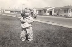 My aunt Susan, around two years old. According to my dad when he was alive, their neighborhood is now Parking Lot C for LA International Airport, which I believe since their street address of 9025 Goebel Avenue does not show anywhere on Google Maps to exist (I confirmed this from their WW2 food ration books I have saved). Or the street was renamed? Can anyone ID the car in the background?? View full size.