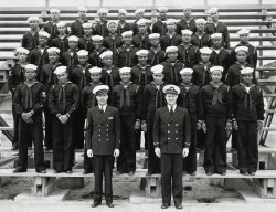 My grandfather Thomas A. Hawkins and his Navy peers in their enlistment group photo, about 1943. He enlisted in the Construction Battalion and was separated in 1953 as a Boatswain's Mate (Stevedore) Petty Officer First Class. This photo was taken either in Columbia or Charleston, S.C., where he entered). My grandfather is the second person directly above the head of the officer on the right. View full size.
My Grandfather&#039;s GenerationNew member, been browsing the site for a while now, couldn't resist wanted to post a photo. Love reading the comments, people's imaginations, thoughts and knowledge related to the photos.
This photo stars my own grandfather 
For most of us African Americans, WW2 was the beginning of our life. The first war that AA's were allowed to participate in and therefore a gateway for AA's to get out of poverty and away from segregation, and have a better opportunity for education, employment, housing, and treatment. This basically became part of the AA great migration from the south to cities in the north and west. For a lot of young people, there was no other way out except this way, all of them didn't know what they're future held. Some may have died during the war or because of the war, my grandfather's eldest brother also served during this war, the Army's Police force (196th Co.) and 15 years after being separated, died a tragic death. He was only 38, no children.
I ask questions about the men in this photo, I think all of Americans echo the same stories as African Americans when it comes to WW2. This was the beginning of all of our lives, and I think a lot of us in my generation and my parents' generation can say, if it wasn't for this war we would still be living there, we would not have what we have today. That's personal in our lives, but also as a people, a nation, AA's could say, you let us fight in the war but you won't let us vote, this war was the turning point of the treatment of blacks and women, since this country fought discrimination in another country, but had it's own to deal with in this country.
These 39 men were going to participate in this war and did not know what the future held, but they were pioneers, they are post-WW2 fathers, the military, this country and all that this country stands for was built on their backs. There so much I see in this photo, what it means, maybe some understood that, maybe most didn't, but they were going to do something none of them knew what they were doing. This is a great photo, this is my grandfather's generation, but this is the generation that started it all for me.
WW2 bridges the gap between what life was before and what life is after, this connects the two generations, where we came from, where we are, and where we're going. Look at these men's faces, and see the unsurety, uncertainty, not knowing what lies ahead, just young and black and don't know what's expected of them.
Wonderful PictureThank you for posting this wonderful picture. I am sure that most, if not all, of these men, who proudly served their country during WW2, went on to lives that were much better than the ones they left behind when joining the Navy. Hopefully you will post some more of your family pictures.
Thank you Thank you for submitting this picture of your grandfather, and his brothers in arms. Also, thanks for the comments in your post above detailing the point in American history that African-Americans were finally given an opportunity to show their true value, and worth to America. 
I appreciate your Grandfather's service to our country, and to all those of the "Greatest Generation."
My granddad was a Seabee, tooMy grandfather was in his early 40s and joined the Seabees after Pearl Harbor was bombed. He was a contractor and carpenter in a tiny Colorado mountain town, and was posted to Hawaii.
As a kid in the 1960s-1970s, I didn't understand the importance of the gifts he gave us - sailor hats and duffel bags and the denim jacket with a Seabee patch on the shoulder.
We have no photos of his time with the Navy. Thanks for this picture, it gives me a little window to see back what Granddad was doing during the war.
(ShorpyBlog, Member Gallery)