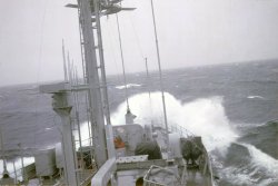 A picture from the bridge of the USS Palm Beach (AGER-3) taken in the Norwegian Sea in the summer of 1968.  She was 170 feet long and displaced 700 tons.  She was built by Higgins Boats in New Orleans during WW2 as an AKL and served as an internal engine repair ship in the Pacific.  Note the twin 20mm mounts covered in tarps. She was also armed with four .50 caliber machine guns, ten Thompson submachine guns, seven .45 cal pistols and one M-1 carbine. Palm Beach was the sister ship of the ill fated USS Pueblo. View full size.
[Did you take this photo? If not, who did? -tterrace]
Palm Beach pictureWe had a closed bridge with an open bridge above it. All the ship control functions were handled on the closed bridge. Shorpy has another picture of the Palm Beach which I took in Holy Loch, Scotland tied up alongside a submarine and a submarine tender.
[It was too small to publish in the Gallery. -tterrace]
Who took the picture?I did. I was her First Lieutenant/Gunnery officer.
[Thanks. That's info that's good to include in your captions. -tterrace]
Ride Captain, Ride!Did this vessel have an outdoor bridge? If so, it must have been a cold ride while on watch. Please post anymore photos that you might have, I always was fascinated by the small sigint ships of that era.
(ShorpyBlog, Member Gallery)