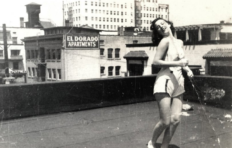 Woman posing on a rooftop. Found in a lot of photos purchased at auction. View full size.
