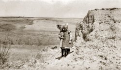 My grandmother Dottie and a schoolmate photgraphed by the teacher of a one-room schoolhouse in the early 1920s in rural SW Nebraska. Note the two "spies" peeking from behind the ridge in the center of the photo. View full size.
(ShorpyBlog, Member Gallery, Kids)