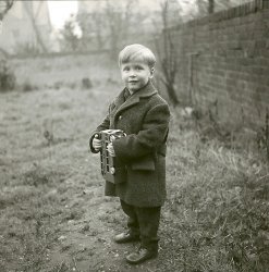 My Brother, Winter 1963 in Reading, England, taken by my Aunt. To me this is the perfect portrait, the positioning, lighting, atmosphere, his expression. I just love this photo. View full size.
(ShorpyBlog, Member Gallery, Kids)