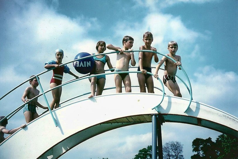 Me, right, about to slide into the pool on holiday in West Germany, August, 1970. My two brothers are nearest me. If I look scared, that's because I am. Scanned from Agfa slide. View full size.
