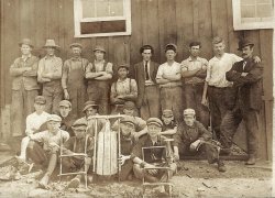 Original print from Old Sled Works museum collection, c. 1920s. An enthusiastic looking bunch. That could be the owner to far right, wearing the bowler hat, and another manager type in center with tie. It looks like the factory employed young teens. Some have hammers in their hands.
I cannot confirm that this image is from our Duncannon, PA location. The building doesn't look familiar, however, the sled in the middle reads "Victor" and looks similar to our small Lightning Guiders from that era. The factory did make personalized sleds for kids and this could have been one for a boy named Victor. View full size.
SledsIn the 1920s, the major East Coast trade-names for sleds were Victor and Flexible Flyer.  I suspect that this was one of the former.
(ShorpyBlog, Member Gallery)