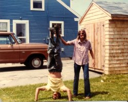 The fellow upside down is my wife's father Richard Dostie, with his sister helping him keep his balance while smoking. Taken in Rockland, ME, sometime in the early 1970's. View full size.